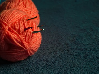 Skein of colored yarn on a dark background.