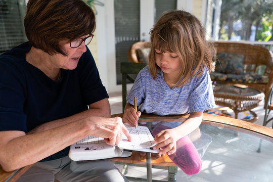 Grandmother and granddaughter doing a math puzzle