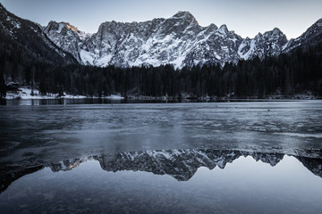 beautiful frozen fusine lakes in julian alps, italy