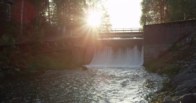 Water running over an old mill dam in beautiful sunset. Shot on Red Epic at 5K.