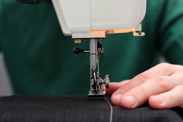 processes of sewing Linum on the sewing machine sew women's hands sewing machine Linum. sewing machine and female fingers out of focus