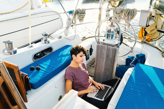 Woman using laptop in boat