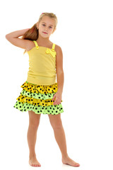 A little girl fixes her hair.