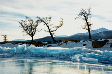 Pure transparent ice hummocks of frozen lake in winter