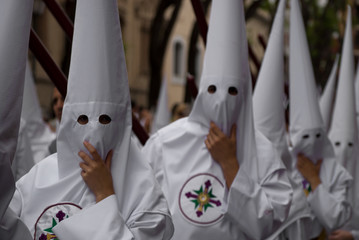 The costumes of men and women hooded in Catholic processions