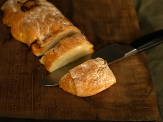 Ciabatta. homemade italian ciabatta bread top view. Bread with cheese. Sliced fresh bread on a wooden tray.