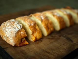 Ciabatta. homemade italian ciabatta bread top view. Bread with cheese. Sliced fresh bread on a wooden tray.