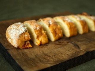 Ciabatta. homemade italian ciabatta bread top view. Bread with cheese. Sliced fresh bread on a wooden tray.