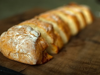 Ciabatta. homemade italian ciabatta bread top view. Bread with cheese. Sliced fresh bread on a wooden tray.