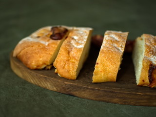 Ciabatta. homemade italian ciabatta bread top view. Bread with cheese. Sliced fresh bread on a wooden tray.