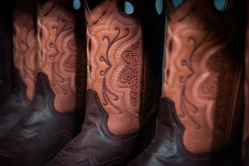 Traditional American handmade leather Cowboy boots, Western show, rodeo market and riding gear on...