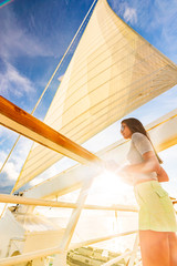 Luxury travel elegant woman on cruise ship yacht on jet set vacation sailing around the world. High...