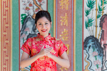 Portrait of beautiful asian woman in Cheongsam dress,Thailand people,Happy Chinese new year concept