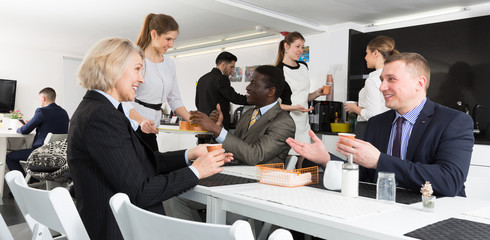 Smiling business people spending free time  at coffee break