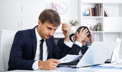 two depressed men colleagues in office .