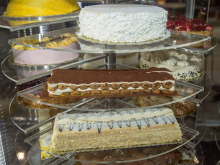 Several Types of Stuffed Cakes inside a Pastry Display Stand