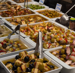 Barcelona Spain Market Variety assortment diverse of fresh healthy tasty green and black olives bowls for sale on open street city market.