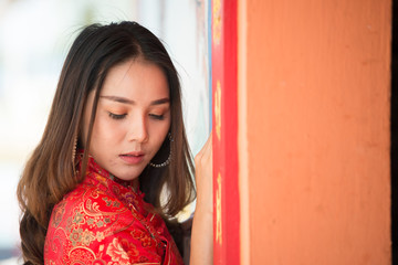 Portrait of beautiful asian woman in Cheongsam dress,Thailand people,Happy Chinese new year concept