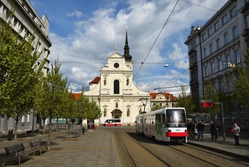 Obraz premium April 16, 2017, the city of Brno. - Czech Republic - Europe. St. Thomas Church in the center and public transport - tram.
