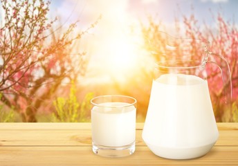 Glass of milk and jug on  white