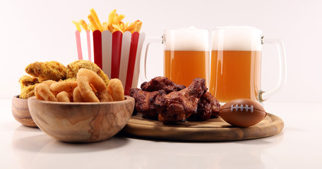 chicken wings, fries and onion rings for football on a table. Great for Bowl Game