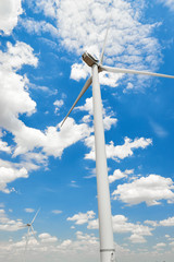 The wind generator is in bright cloudy sky. Eco energy concept.