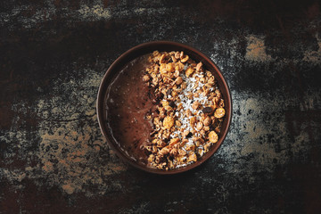 Healthy breakfast bowl with chocolate yogurt and granola.