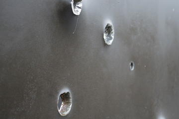 Armor shot through with bullets. Bullet holes