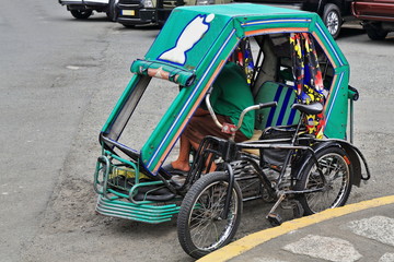 Filipino pedicab waiting for customers. Muralla or Curtain Wall Street-Intramuros-Manila-Philippines-0977