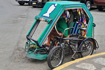 Filipino pedicab waiting for customers. Muralla or Curtain Wall...