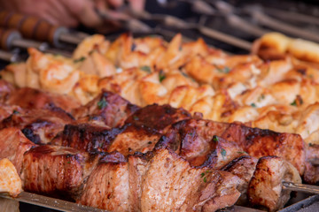 Grilled shish kebab from pork meat and on the back of the grill from chicken meat