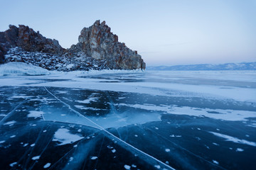 Ice on Lake Baikal. Shamanka rock. Evening landscape.