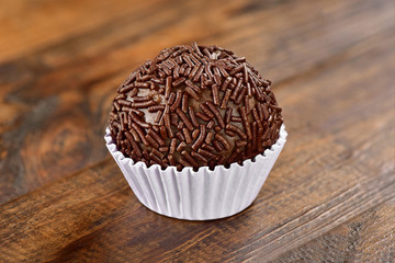 Brigadeiro isolated on wooden background