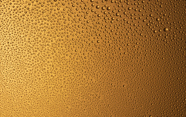 Background of water drops on glass. Gradient gold color.