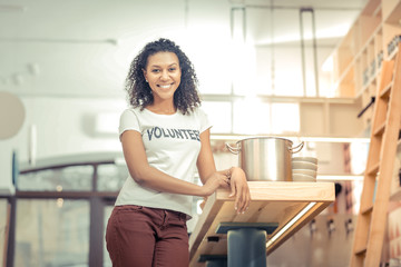 Delighted nice woman standing in the kitchen