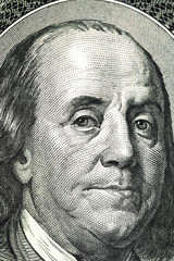 Benjamin Franklin's portrait on one hundred dollar bill close up