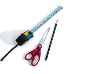 Roulette, scissors and pencil on white background