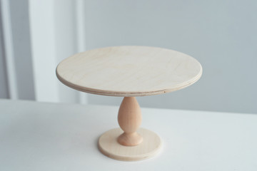 Empty wooden stand for cake isolated on white background