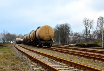 Fototapeta na wymiar Railway tanks, transportation of oil, gasoline, oil or gas by rail. Logistics of transportation of goods by train by rail