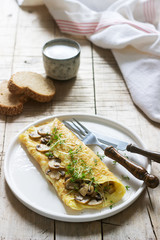 Vegetarian breakfast, omelette with mushrooms and cress, served with rye bread and coffee with milk. Rustic style.