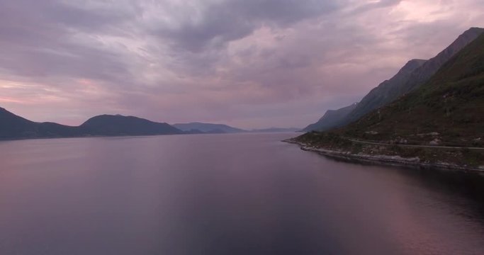 Aerial timelapse of Vartalfjorden in &radic;&ograve;rsta in Norway. Cars driving by with beautiful colourful sky.