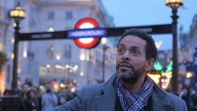 Man on a sightseeing trip in the streets of London at Piccadilly Circus