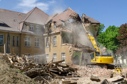digger demolishing houses for reconstruction.