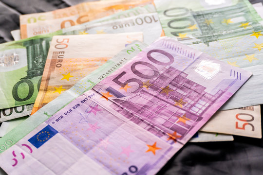 Euro banknotes in salary envelope. Open envelope with money banknotes on table. White envelope with Euro bills. Closeup on Envelope full of euro cash. Euro money currency. International monetary