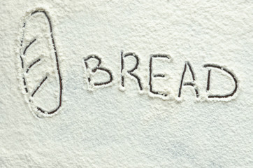 Texture of white flour and written the word bread.