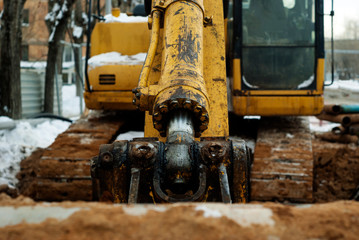 Fototapeta na wymiar bucket cylinder of old excavator in winter outdoor, close-up