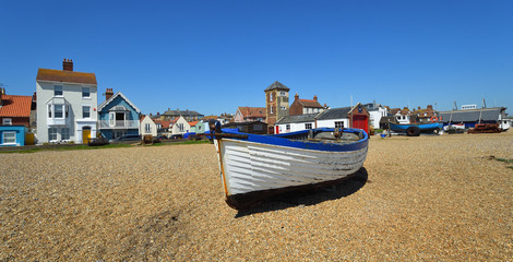 Aldeburgh beach with boats and old Lifeboat station with tower.