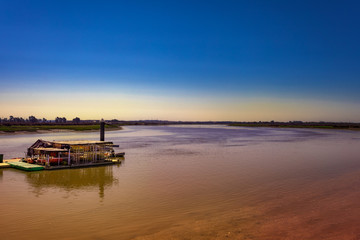 Landscape of a pier in a wide river.