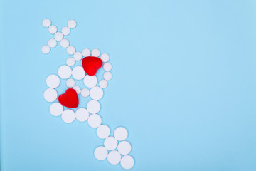 Concept of treatment of male and female genital disorders.Gender symbols of man and woman from white pills on blue background. Copy space for text.