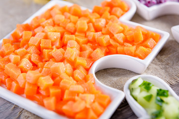 Carrots in a plate. Chopped finely carrots for salad. Fresh carrot.